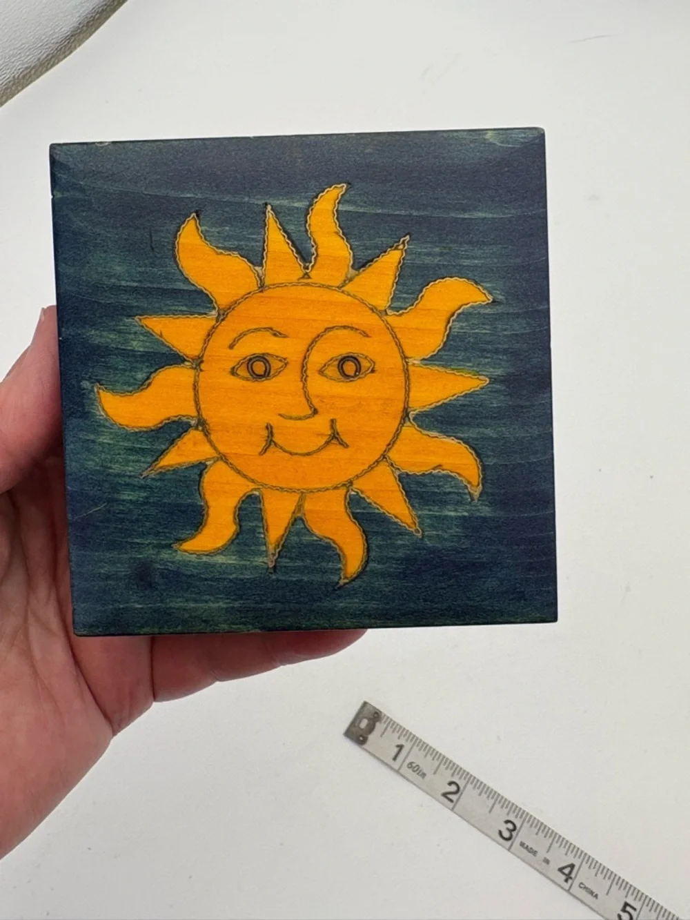 Bright Yellow Sun on Deep Blue Wooden Box